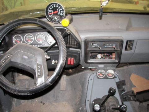 1988 Ford Bronco - Interior view of a 1988 Ford Bronco, aftermarket gauges and a tachometer.