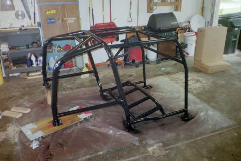 1988 Ford Bronco - Roll cage assembly in a garage, possibly for a custom build or restoration project.