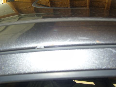 2007 Ford Mustang - Close-up view of the edge of a car's roof, showing imperfections in the paintwork.