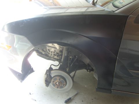 2007 Ford Mustang - Car's front fender and wheel well are visible, with brake and suspension parts exposed.
