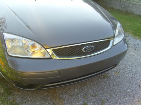 2007 Ford Mustang - The front grille and headlights of a gray Ford Focus are visible.