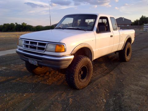 1994 Ford Ranger - This white 1994 Ford Ranger pickup truck features a lifted suspension and off-road tires, ready for adventure.