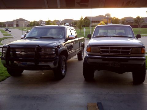 1994 Ford Ranger - A silver Ford Ranger and a dark Chevrolet pickup truck are parked in a driveway.
