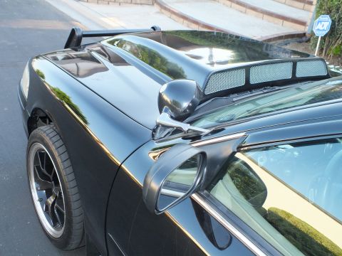 2003 Ford Crown Victoria - Overhead detail of the car's vented hood scoop, A-pillar and folding side mirror.