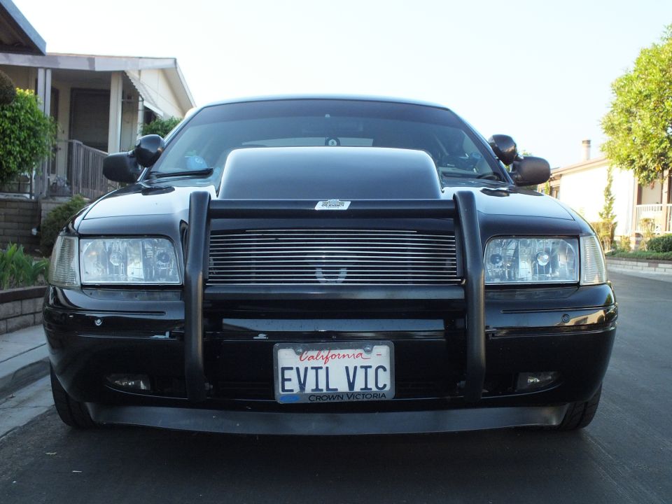 Front view of black Ford Crown Victoria with brush guard and California EVIL VIC plate