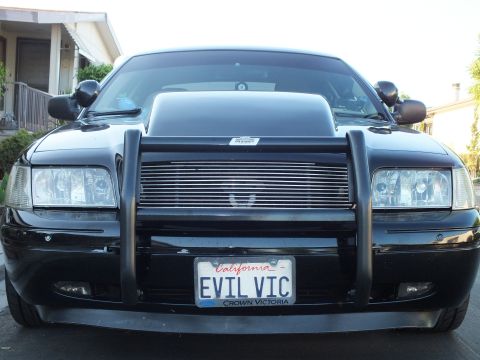 2003 Ford Crown Victoria - Close front view showing the billet grille insert, push bumper and Crown Victoria plate frame.