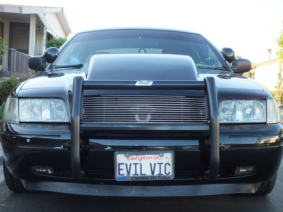 Front grille of black Crown Victoria with billet grille, brush guard and EVIL VIC plate