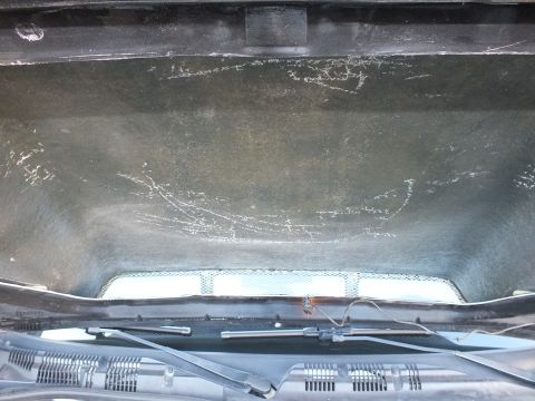 2003 Ford Crown Victoria - Detail of the cowl panel, wiper and vented scoop opening beneath the car's raised hood.