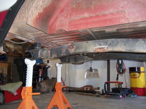 1968 Ford Bronco - Underbody view of a vehicle undergoing work, showing frame and floor pan details.