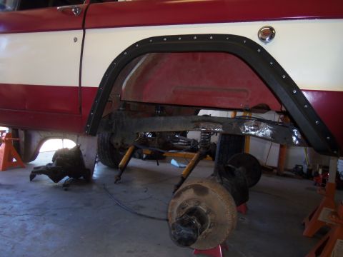 1968 Ford Bronco - The vehicle is in a garage with its rear axle removed and the transmission exposed.