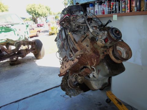 1968 Ford Bronco - Engine assembly and vehicle chassis are visible in a garage setting.