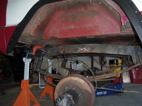 1968 Ford Bronco - Underbody view of a vehicle being worked on, showing suspension and frame details.