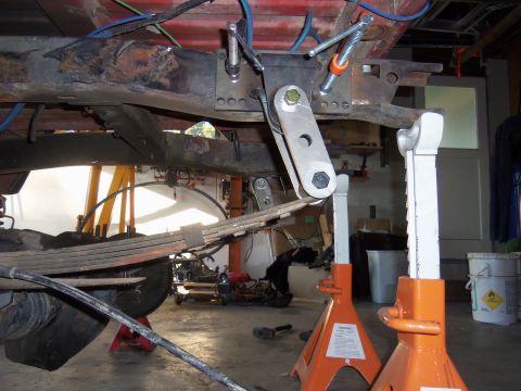 1968 Ford Bronco - Custom linkage and suspension components are visible as the vehicle frame is supported by jack stands.