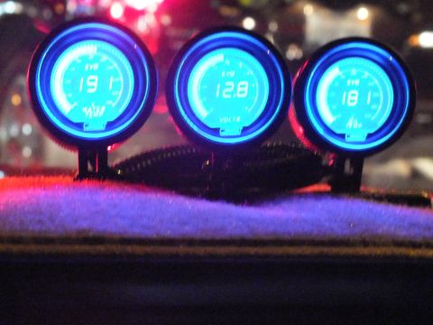 2003 Ford Crown Victoria - Trio of blue EVO gauges glows on a dash showing 19.1, 12.8 volts and 18.1 readouts.