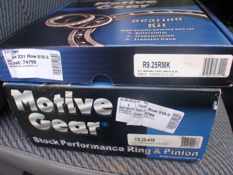 2000 Dodge 1500 - Two boxes of Motive Gear automotive parts, including a bearing kit and a ring & pinion set, are stacked on a seat.