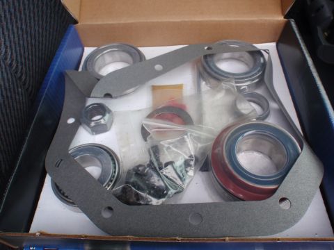 2000 Dodge 1500 - A box contains various automotive parts, including bearings and gaskets, ready for installation.