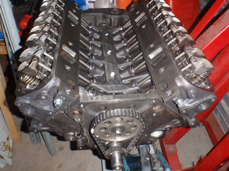 V8 engine block showing cylinder heads, valve train, and timing chain assembly