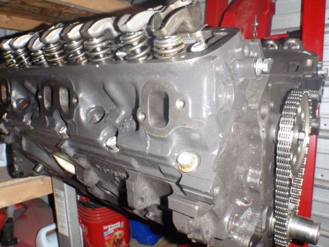 2000 Dodge 1500 - Close-up of an engine block with visible valve train components and timing chain assembly.