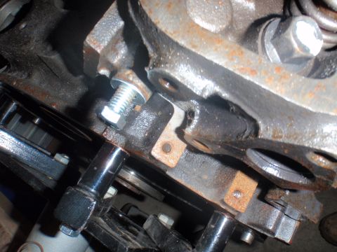 2000 Dodge 1500 - A close-up view of an engine component, showing a bolt and mounting brackets.