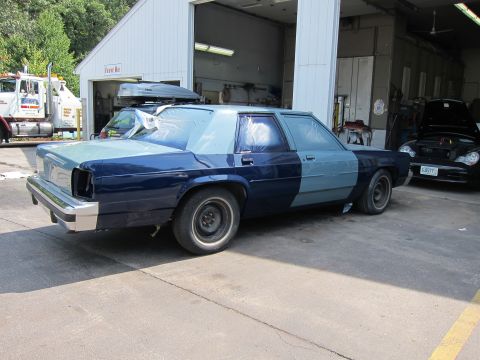 1991 Ford LTD Crown Victoria - A 1991 Ford Crown Victoria LTD is prepped for painting inside a garage bay.