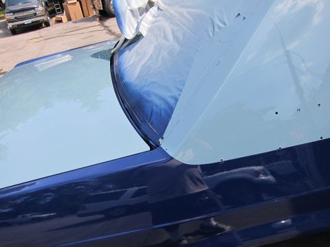 1991 Ford LTD Crown Victoria - A car's hood and fender are masked off for painting, revealing a two-tone finish.