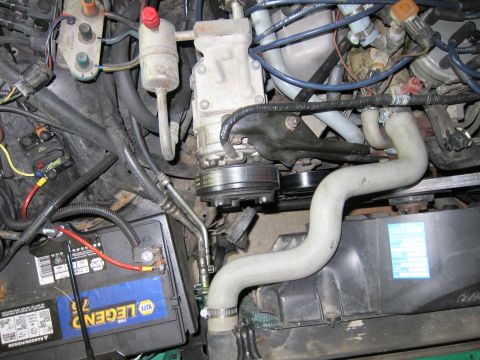 1991 Ford LTD Crown Victoria - Close-up view of a vehicle's engine compartment, showing various components and wiring.