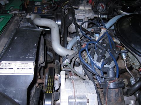 1991 Ford LTD Crown Victoria - Close-up view of a vehicle's engine compartment, showing various mechanical components and wiring.