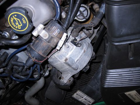 1991 Ford LTD Crown Victoria - Close-up view of engine components including the distributor and ignition coil.