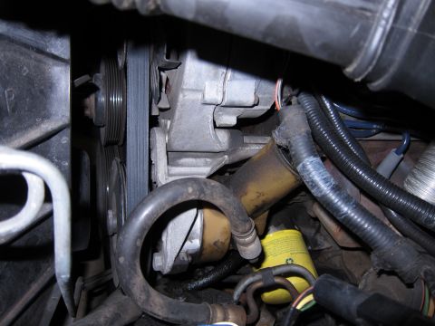 1991 Ford LTD Crown Victoria - Close-up of engine components including alternator, serpentine belt, and oil filter.