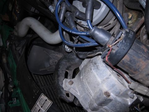 1991 Ford LTD Crown Victoria - Engine bay details showing various components like spark plug wires and a radiator hose.