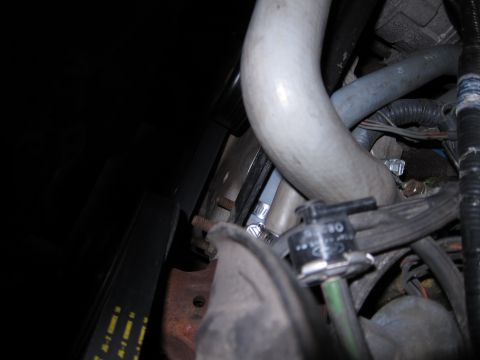 1991 Ford LTD Crown Victoria - Close-up of engine components in a 1991 Ford Crown Victoria LTD, showing hoses and a valve.