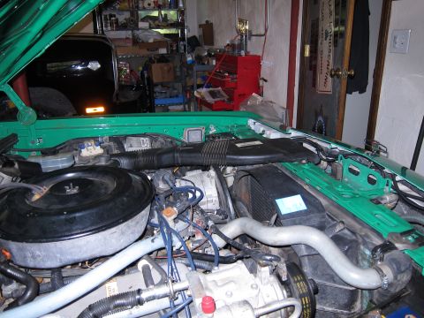 1991 Ford LTD Crown Victoria - Close-up view of a car's engine bay, showing components like the air filter housing and radiator.
