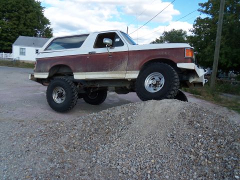 1989 Ford Bronco - This lifted 1989 Ford Bronco is positioned on a mound of gravel, its off-road capabilities.