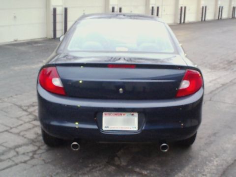 2000 Dodge Neon - Rear view of a dark blue sedan with dual exhaust pipes and a Wisconsin license plate.