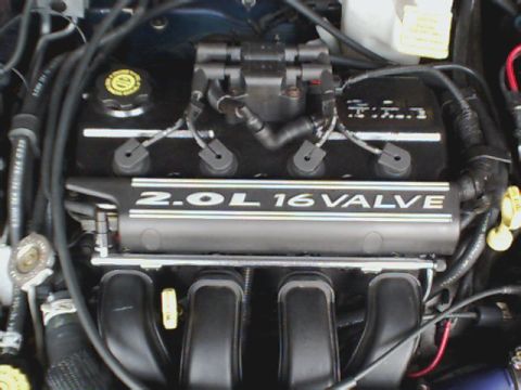 2000 Dodge Neon - The engine bay of a vehicle shows the 2.0L 16 valve engine cover and associated components.