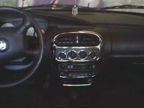 2000 Dodge Neon - Interior view of a car's dashboard, highlighting the center console with chrome trim.
