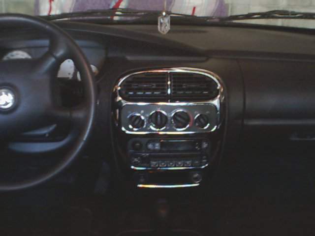Dashboard with chrome accents around vents and controls