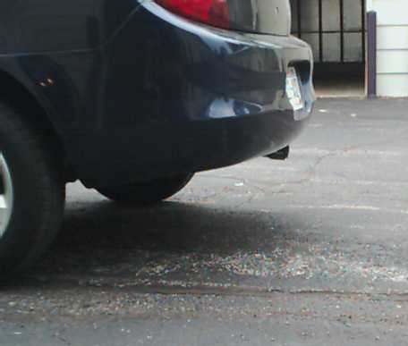 2000 Dodge Neon - Rear view of a dark blue sedan, showing the bumper and taillight with a license plate.