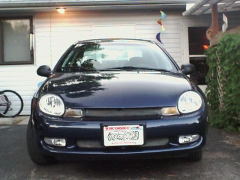 2000 Dodge Neon - A dark blue 2000 Dodge Neon is parked in front of a residential building.