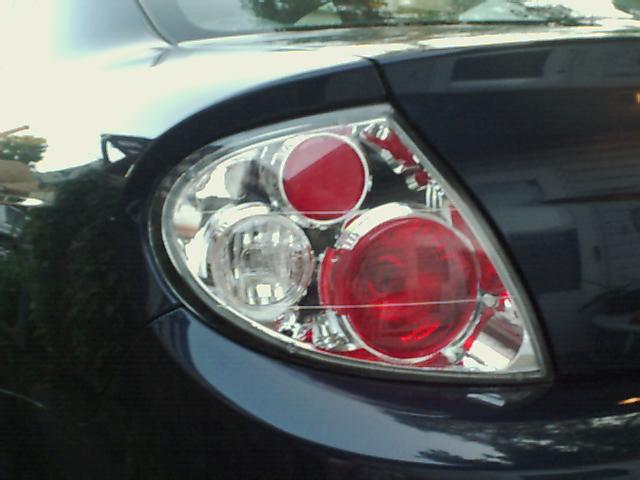 Close-up of a dark-colored car's rear tail light assembly