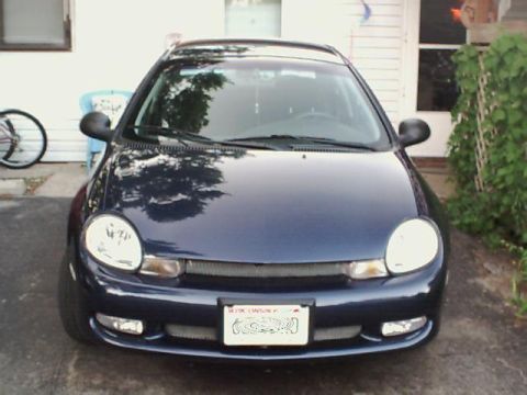 2000 Dodge Neon - The front of a dark blue Dodge Neon is shown parked in front of a house.