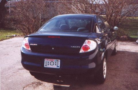 2000 Dodge Neon - Rear view of a dark blue 2000 Dodge Neon sedan parked outdoors. The vehicle features a spoiler and a Wisconsin license plate.