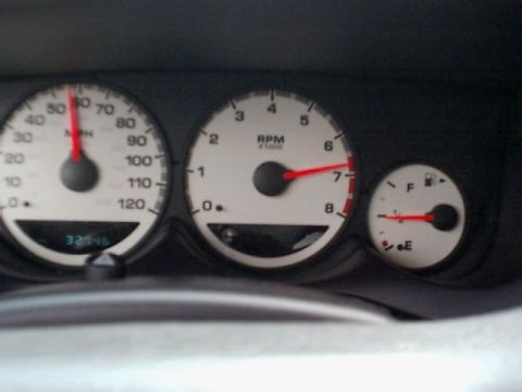 2000 Dodge Neon - Close-up of the instrument cluster, showing the speedometer, tachometer, and fuel gauge.