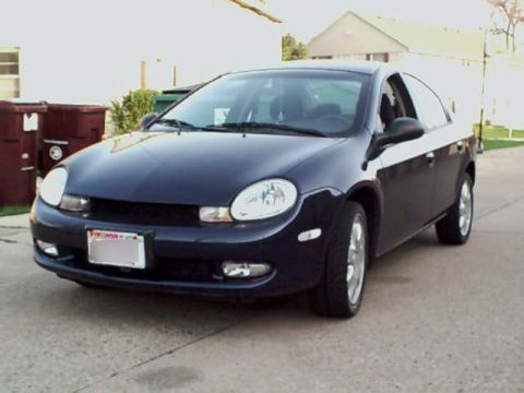 2000 Dodge Neon - A dark blue sedan is parked in front of a house with trash cans nearby.