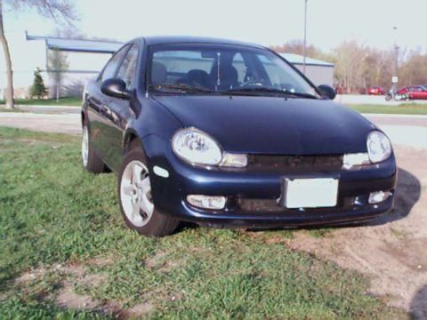 2000 Dodge Neon - Front view of a dark blue 2000 Dodge Neon sedan parked on a grassy area.