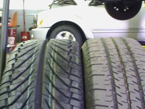 2000 Dodge Neon - Tires are in the foreground, obscuring the front of a white vehicle.