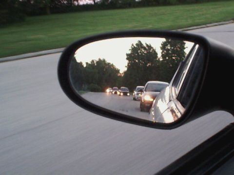 2000 Dodge Neon - A view of traffic on the road as seen in the side mirror of a vehicle at dusk.