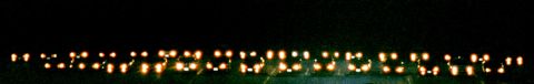 2000 Dodge Neon - Blurry lights create a pattern against a dark background at night.