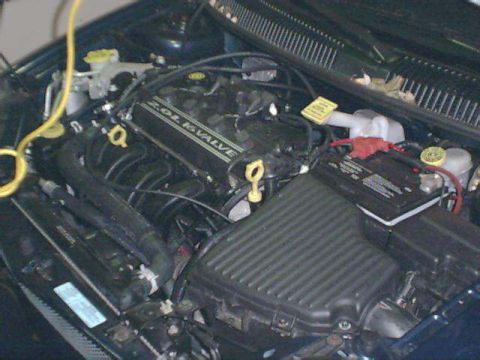 2000 Dodge Neon - Close-up view of a car's engine compartment, showing various components and a Supermotors.net watermark.