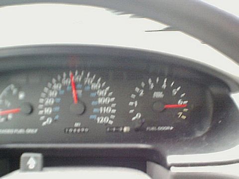 1995 Plymouth Neon - Odometer reads 104499 miles on the dashboard gauges.